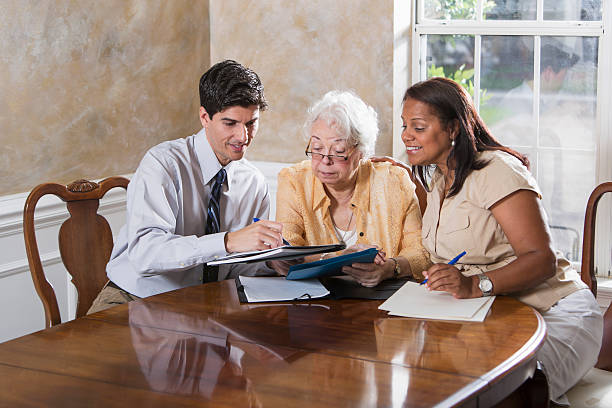 Senior Hispanic woman (70s) getting professional advice.